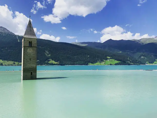 The submerged city and the only bell tower left emerging from the lake in Italy