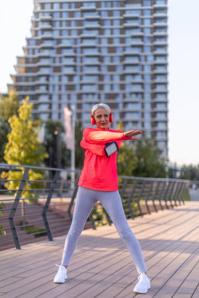 istock Senior athletic woman stretching outside 1342127513