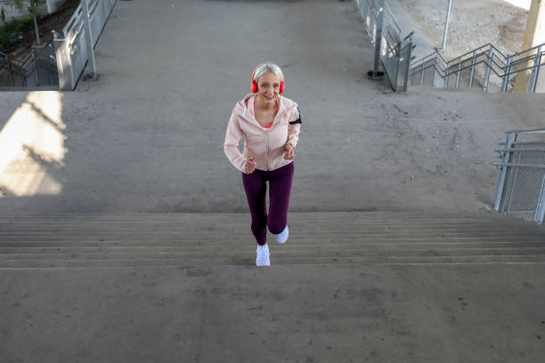 istock Senior athletic woman jogging upstairs 1342127780