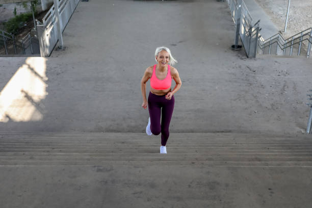 istock Senior athletic woman jogging upstairs 1342127801