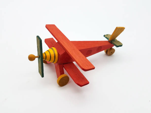 Hand Crafted Toy Airplane Hand made wooden toy airplane on a white background. toy airplane stock pictures, royalty-free photos & images