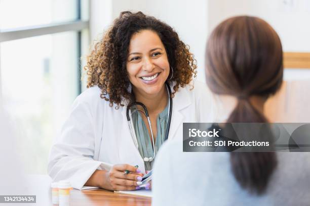Caring Doctor Listens To Patient Stock Photo - Download Image Now - Doctor, Patient, Discussion