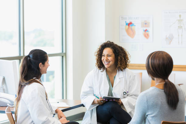 istock Two doctors meet with female patient 1342134446