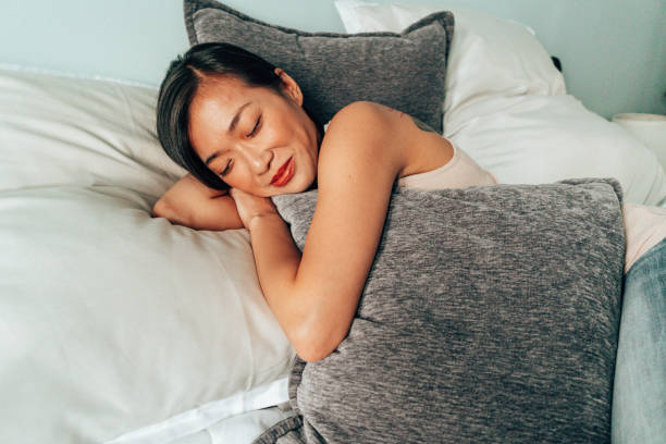 istock chinese woman resting comfy on the bed 1342136743