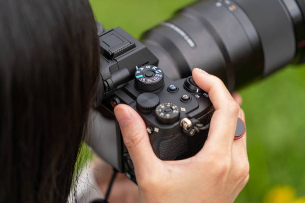 istock Woman with a mirrorless interchangeable-lens camera 1342138995