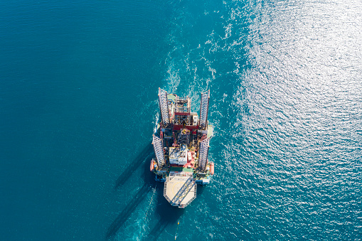 Oil rig on offshore area stock photo. Aerial view offshore jack up rig being towed to the location