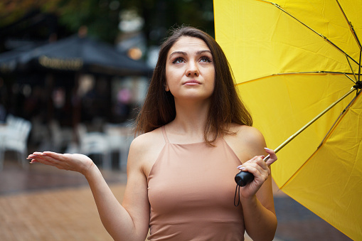 Cheerful young woman holding an umbrella