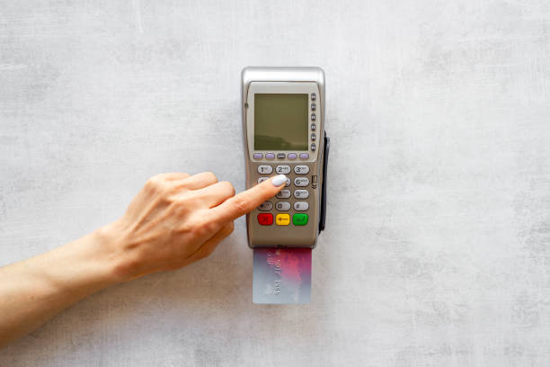 istock Hand with credit card on pos payment terminal. Top view 1342145578