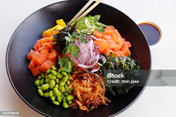 Japanese Poke Bowl With Edamame Salmon Wakame Seaweed Mango Radish Cucumber Onion And Rice Served With Sweet Soy Sauce Healthy Food Concept Stock Photo - Download Image Now