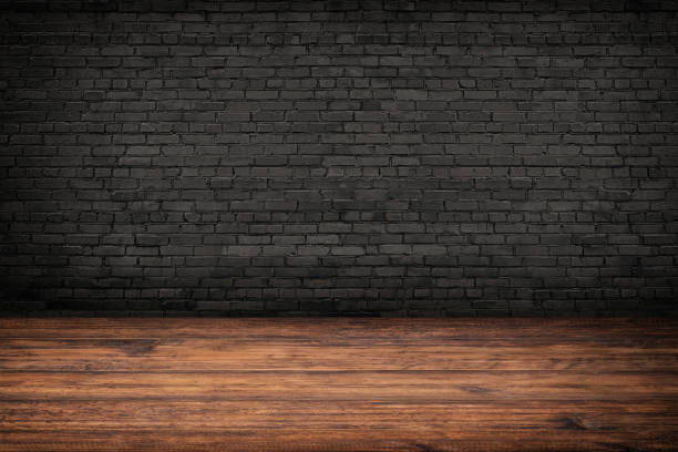 istock rustic interior, old wood floor and black brick wall 1342149453
