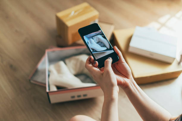 istock Young Asian woman happily using mobile phone to take photos 1342152073
