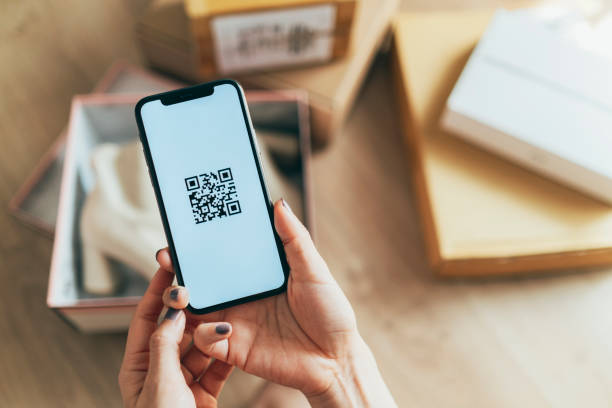 istock Asian woman scanning QR code of parcel 1342152078