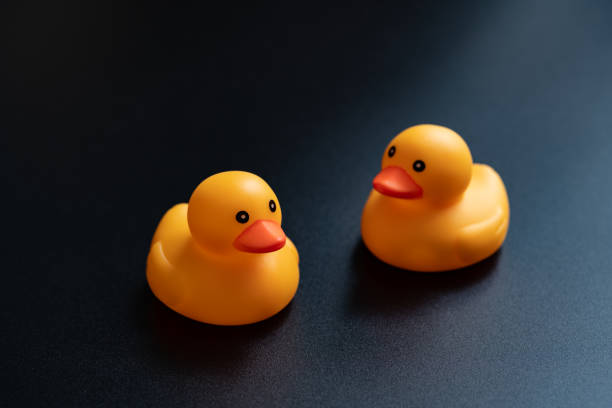 multi-colored rubber ducks in the bathroom arranged in a row