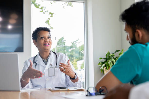 istock Mature Doctor having a discussion with staff 1342154713