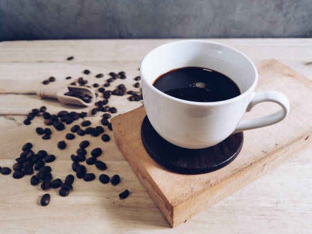 istock Coffee cup and seed coffee on wooden floor 1342154735