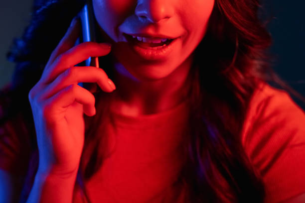istock phone talk online communication woman neon light 1342155725
