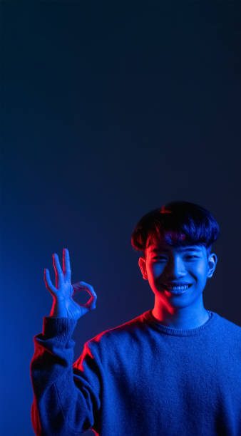 istock okay sign approving man neon light blue color 1342155726