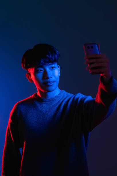 istock phone selfie gadget people man photo neon light 1342155727