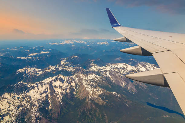 istock Flying over snow capped mountains, view of airplane wing, Seattle 1342156143