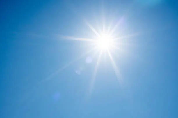 Photo of Direct ray of the sun in the blue sky
