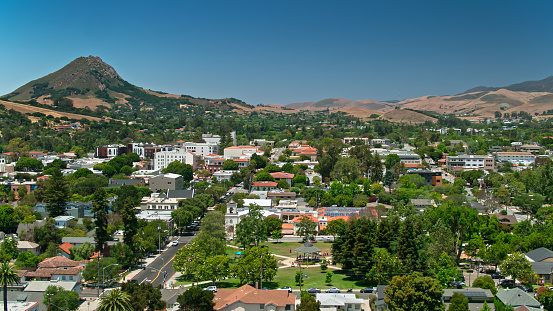 Aerial shot of San Luis Obispo, California on a sunny afternoon in summer, looking over houses in the Old Town Historic District towards Mitchell Park and the downtown. \n\nAirspace authorization was obtained from the FAA for this operation.
