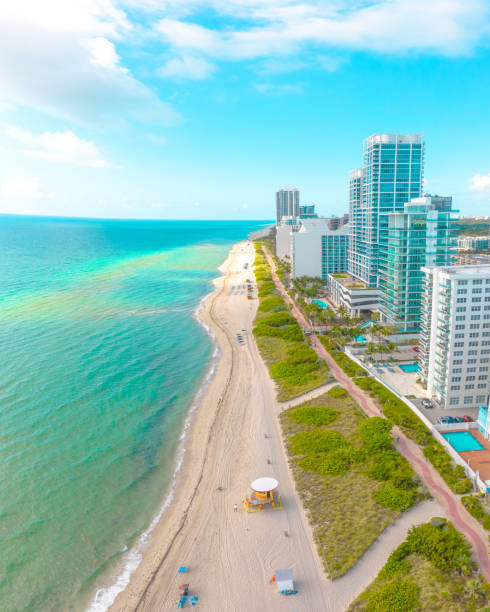 Amazing turquoise ocean water on a white sand beach in Miami Beach Florida USA Modern waterfront architecture on display with blue ocean water and white sand south beach photos stock pictures, royalty-free photos & images