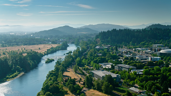 Aerial shot of the Willamette River flowing through Eugene, Oregon on a sunny day in summer.