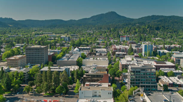 Downtown Streets in Eugene, Oregon - Aerial Aerial shot of Eugene, Oregon on a sunny day in summer, with the distinct shape of Spencer Butte in the distance. eugene oregon stock pictures, royalty-free photos & images