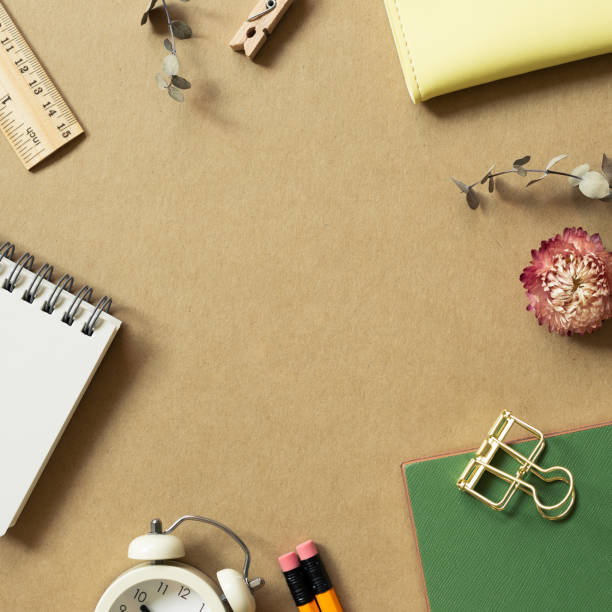istock Various office supplies on brown background. workspace. flat lay, top view, copy space 1342172382
