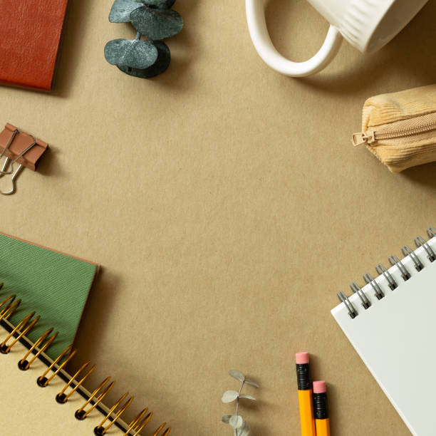 istock Various office supplies on brown background. workspace. flat lay, top view, copy space 1342172950