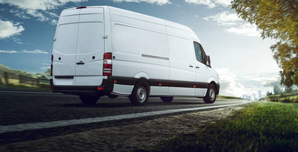 Delivery van delivers on Country Road stock photo