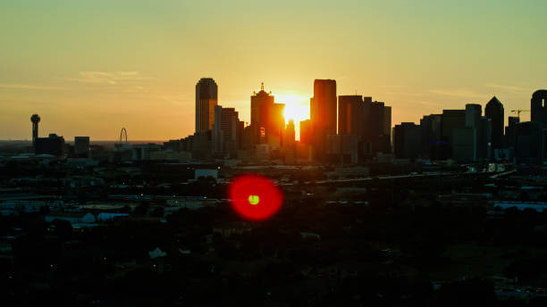 istock Silhouetted Dallas Skyline at Sunset with Lens Flare 1342175542