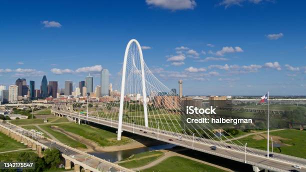 Drone Shot Of Texas State Flag Waving Over Margaret Hunt Hill Bridge With Dallas Skyline Stock Photo - Download Image Now