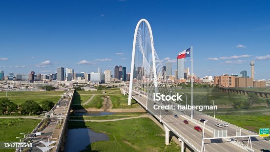 istock Drone Shot of Texas State Flag Waving Over Margaret Hunt Hill Bridge with Dallas Skyline Beyond 1342175548