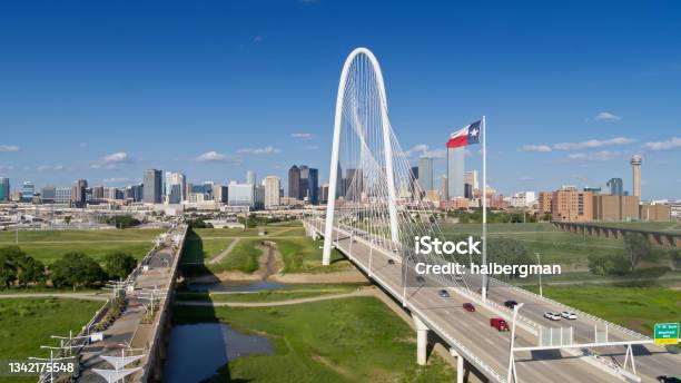 Drone Shot Of Texas State Flag Waving Over Margaret Hunt Hill Bridge With Dallas Skyline Beyond Stock Photo - Download Image Now