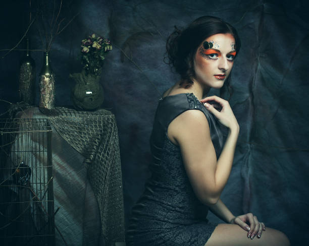 istock young model woman with creative make up sitting on a stool in drama decoration 1342176631