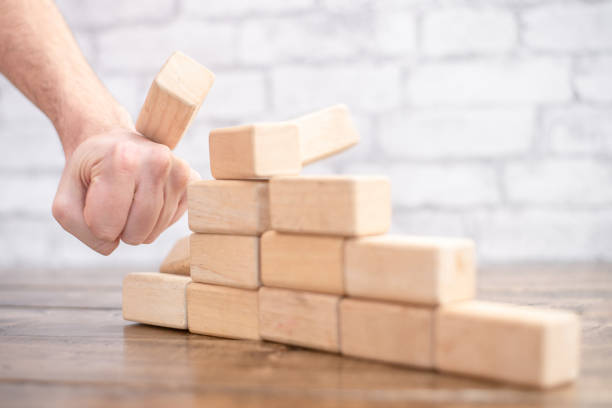 istock Hand Smashing Down a Tower of Blocks 1342177469