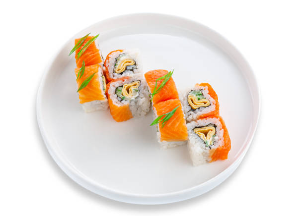 istock Sushi roll with salmon, omelet and vegetables. On a white ceramic plate. White background. Isolated. 1342177557