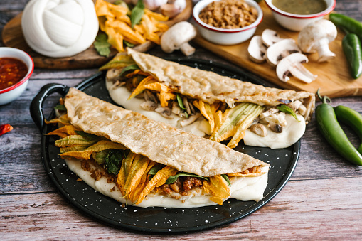 Chicharron and mushroom quesadillas with squash blossom, typical dish from Mexico