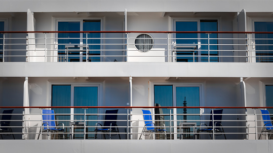 The sun warms the balconies of two decks on a cruise ship docked in Yokohama, Japan.