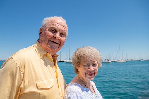 Portrait of a beautiful senior couple ready to go boating on a lake.