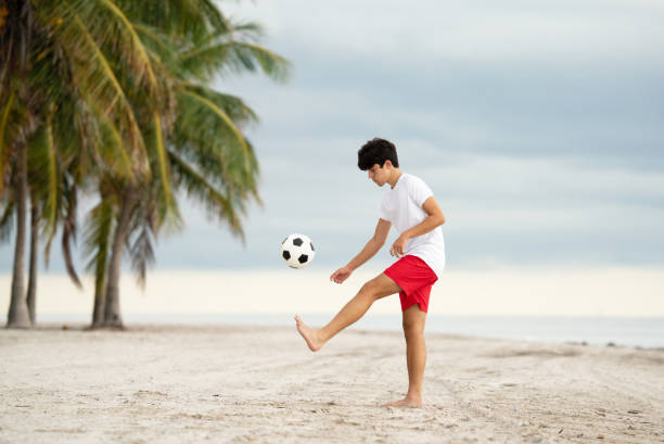istock Teen practicing with a soccer at a beach in Miami 1342185142