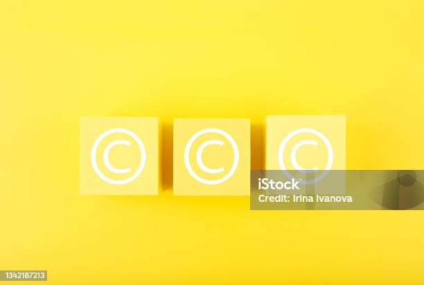 Copyright And Intellectual Property Protection Concept On Yellow Background Stock Photo - Download Image Now