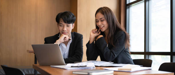 istock Two young business people  discussing financial data on computer laptop together in office. 1342187558