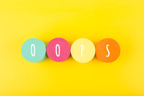 istock Word oops written on colorful round geometric against yellow background 1342188292