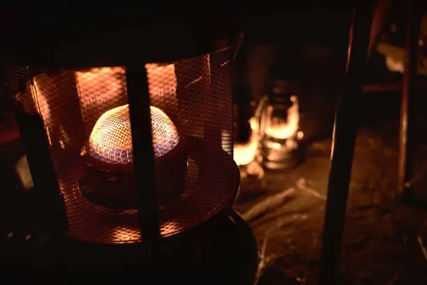 Kerosene heater and lantern shine in the tent of the winter camp