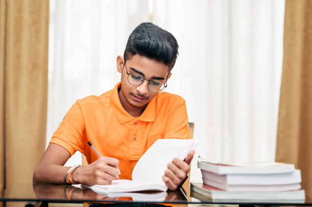 istock Young boy preparing for exam, Studying at home. 1342191949