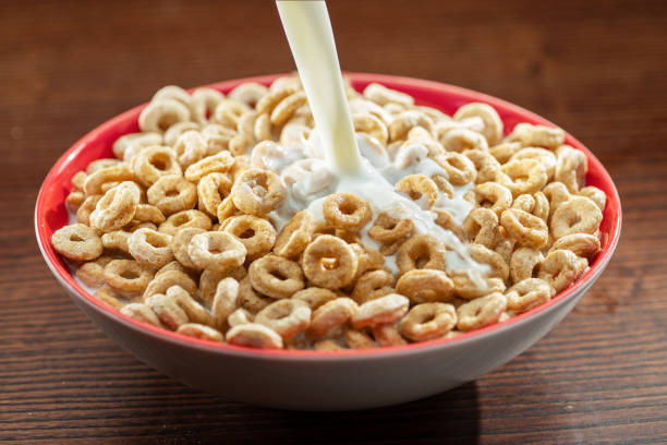 istock Pouring milk into the bowl with corn snacks. Close-up. 1342193002