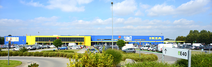 Zaventem, Vlaams-Brabant, Belgium- September 23, 2021: Ikea site, a modern furniture chain. View of exterior building and parking lot. Facade yellow and blue color. Billboard \