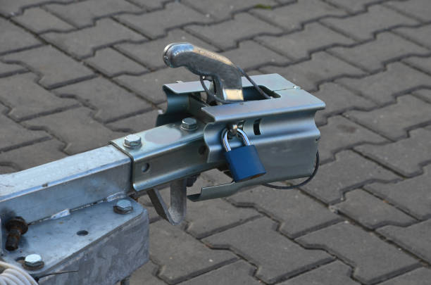 a trailer or caravan, if parked in a car park, must be locked with a special lock on the attachment. metal cover with suction lock a trailer or caravan, if parked in a car park, must be locked with a special lock on the attachment. metal cover with suction lock hitchhiking stock pictures, royalty-free photos & images